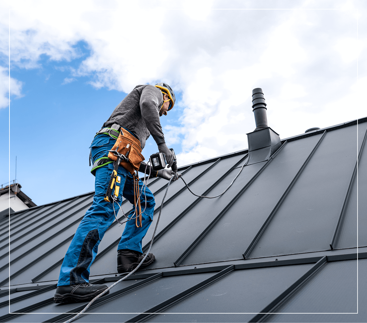 Roofer working on steep metal roof.
