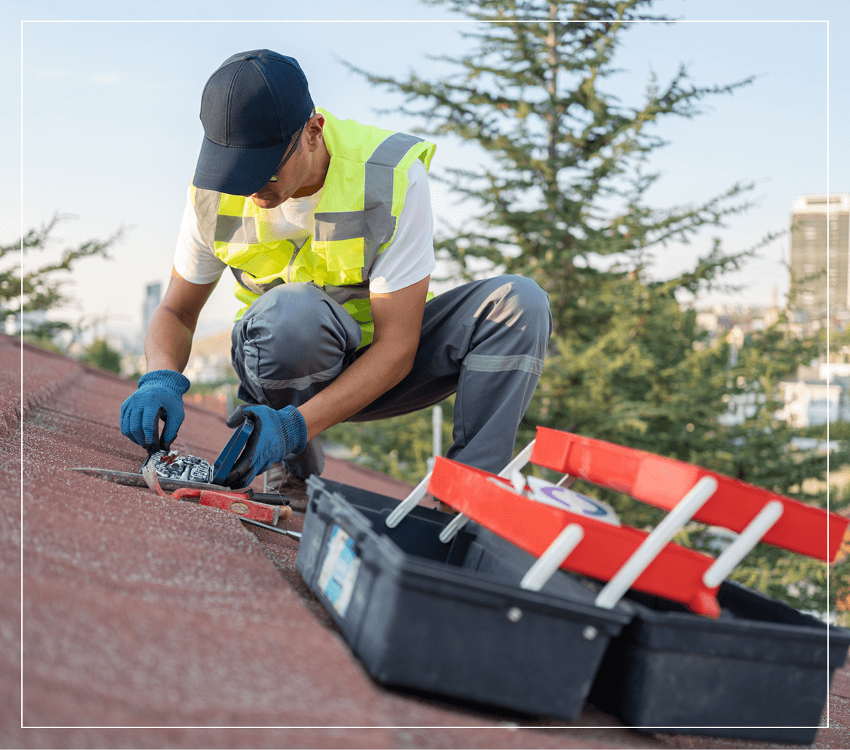 Worker repairing roof with tools and toolboxes.