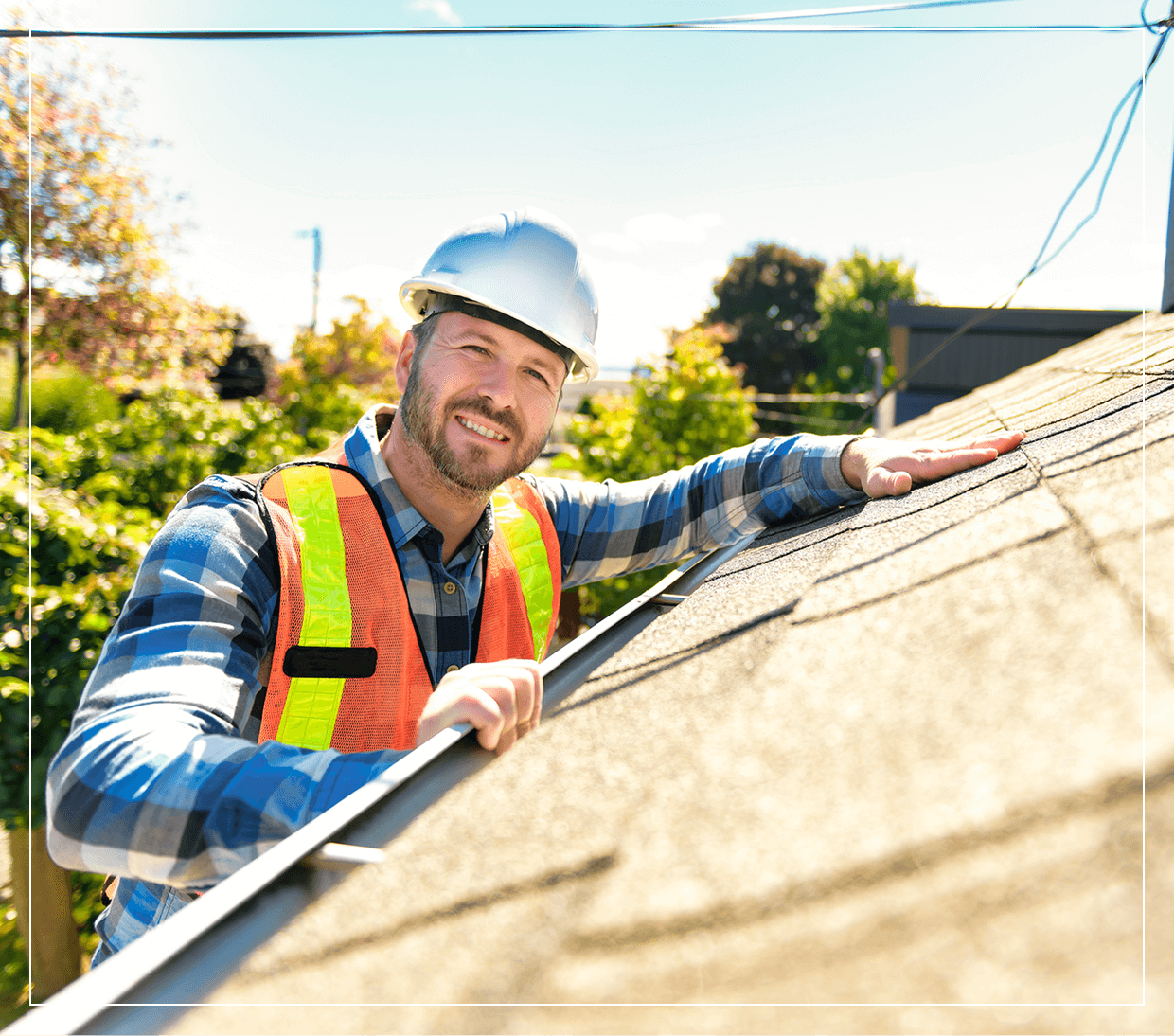Man inspecting roof in safety gear.