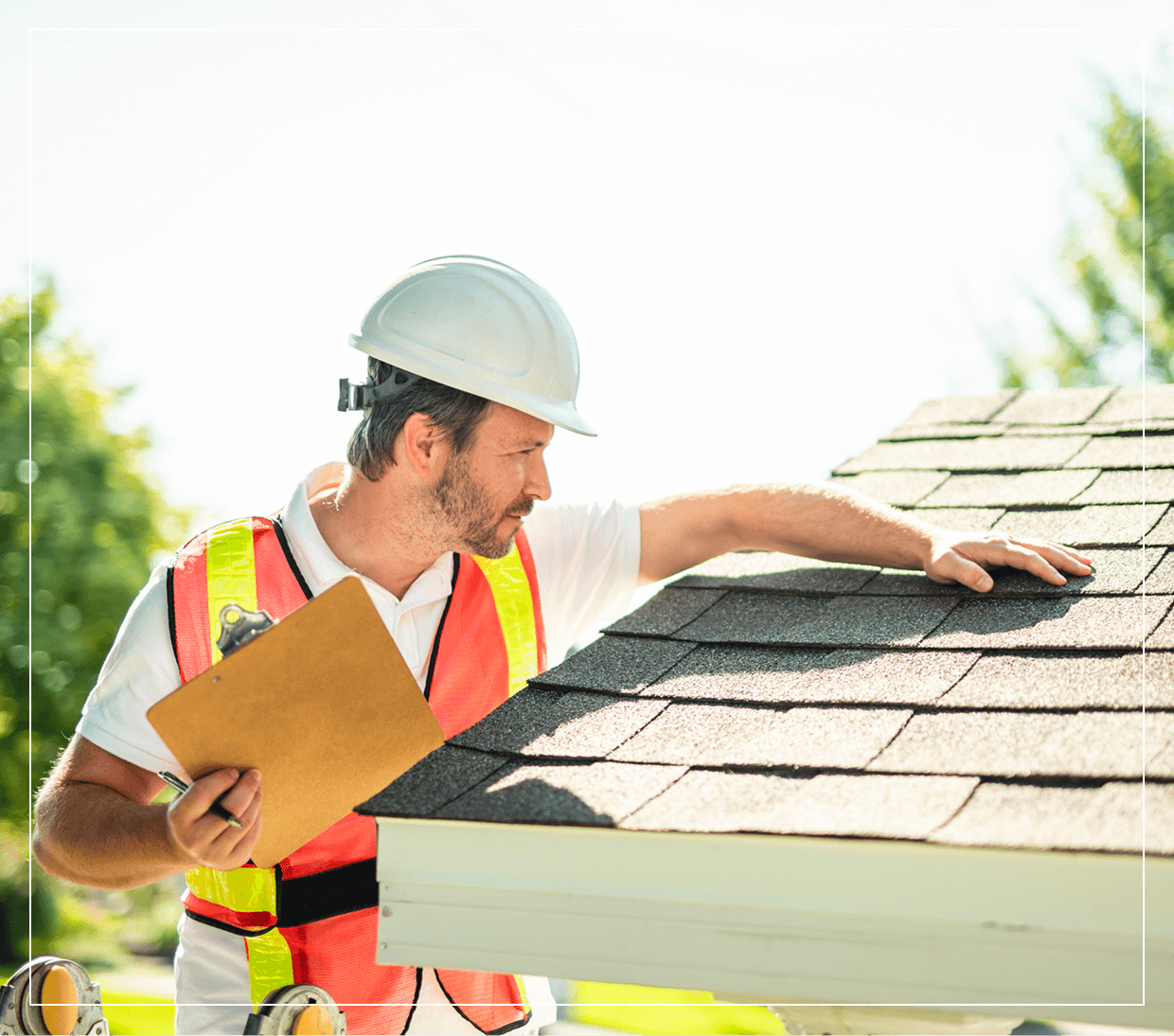 Inspector examining roof shingles with clipboard.