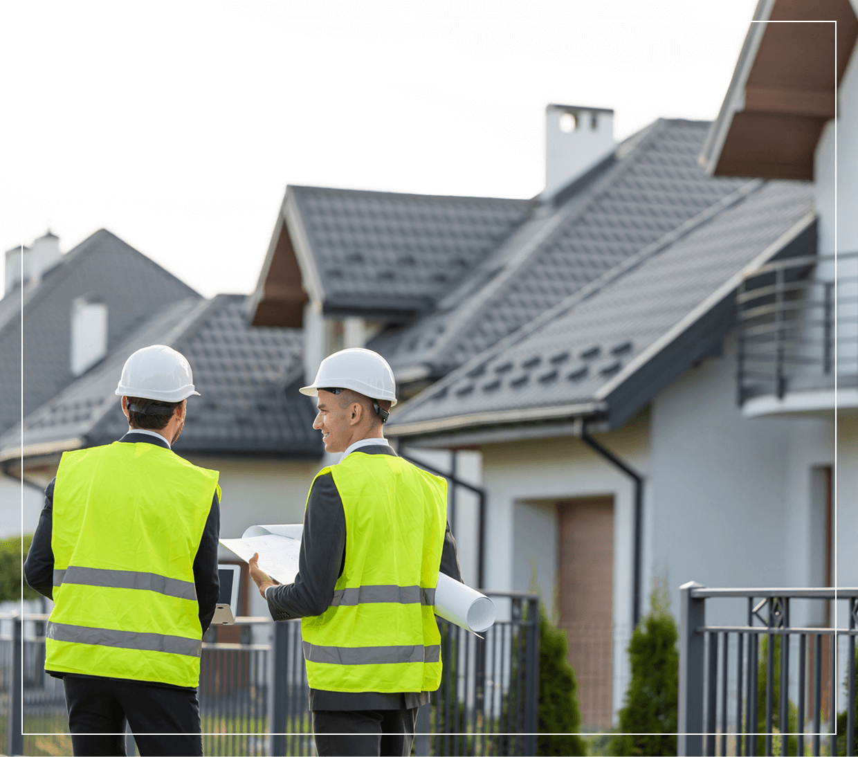 Two construction workers discussing building plans.