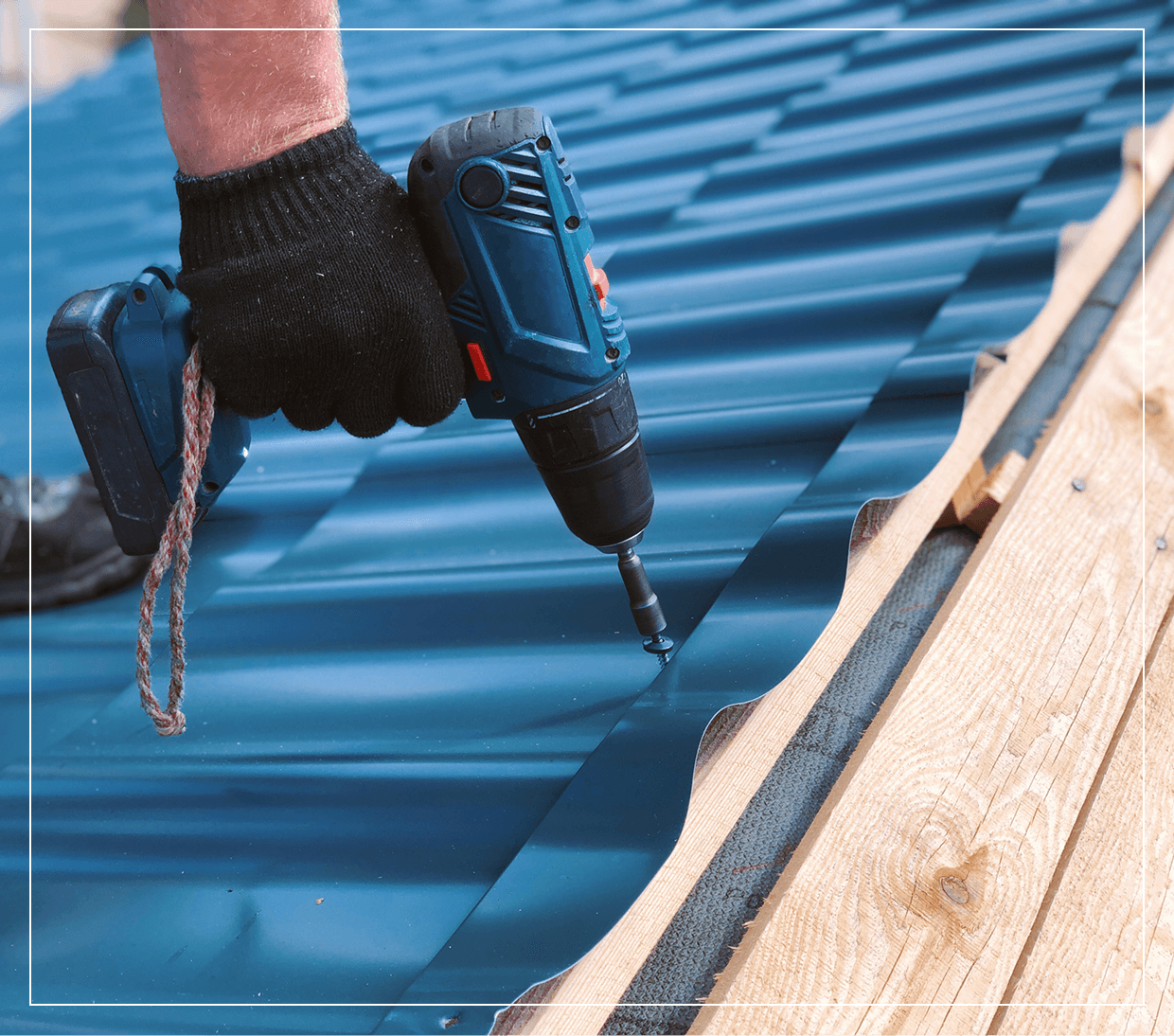 Person drilling metal sheet on roof.